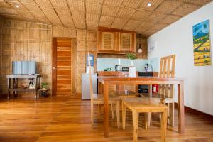 a kitchen with a table and chairs in a room at Boracay Amor Apartment in Boracay