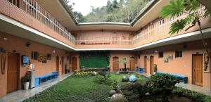 a building with a courtyard with blue benches in it at Alishan MinYue Hotel in Fengshan