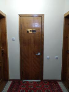 a large wooden door with a sign on it at Samia House Room on Furkat 8 in Tashkent