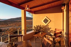 
a patio area with a table and chairs at Karoo View Cottages in Prince Albert
