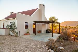 
a large white house with a large window at Karoo View Cottages in Prince Albert

