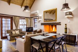 
a living room filled with furniture and a fireplace at Karoo View Cottages in Prince Albert
