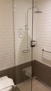 a bathroom with a glass shower with a toilet at Aerotel London Heathrow, Terminal 2 & Terminal 3 in Hillingdon