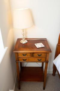 une table avec une lampe au-dessus dans l'établissement PERFECT BUSINESS ACCOMMODATION at SIDINGS FARM - Luxury Cottage Accommodation - Fully equipped & Self Catering, à Pidley