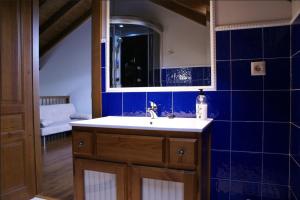 a blue tiled bathroom with a sink and a mirror at Apartamentos La Senda in San Juan de Parres +109 photos