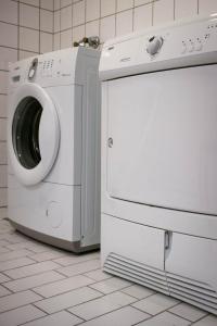 a washing machine and a dryer in a kitchen at City Living Schøller Hotel in Trondheim