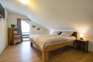 a bedroom with a bed in a room at Ferienwohnungen Alpentraum - Gerstruben in Fischen