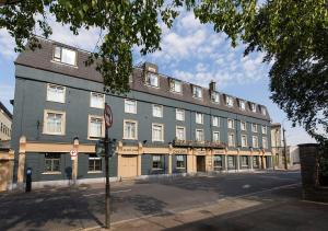a large blue building on the corner of a street at Lawlors Hotel in Dungarvan