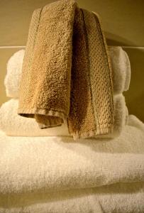 a pile of towels sitting on top of a stack of towels at Gifford House in Edinburgh