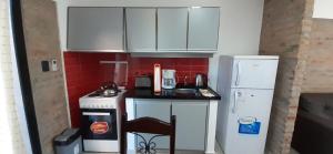 a small kitchen with a counter and a refrigerator at Los Cardenales 3 in Pajas Blancas