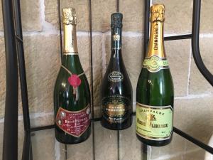 three bottles of wine on a rack at La Halte Effervescente in Épernay
