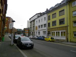 a black car parked on the side of a city street at Astra Hotel in Kaiserslautern