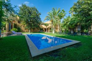 a swimming pool in the yard of a house at Villa Son Floriana in Son Servera