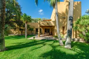 a house with palm trees in the yard at Villa Son Floriana in Son Servera