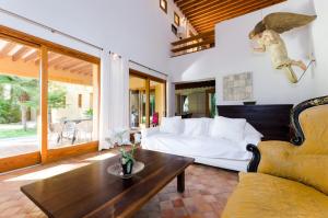 a living room with a bed and a table at Villa Son Floriana in Son Servera +42 photos