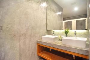 two sinks in a bathroom with a concrete wall at Lanta Hostel in Ko Lanta +111 photos