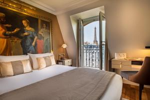 a bedroom with a large painting on the wall at Hôtel Le Walt by Inwood Hotels in Paris