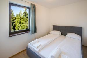 מיטה או מיטות בחדר ב-Jahorinski IZLOG