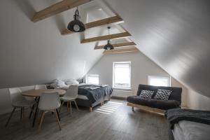 a bedroom with a bed and a table and a couch at Pokoje Na Szlaku in Lądek-Zdrój