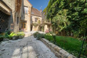 an alleyway in an old house with trees at Clos Grimont in Poligny