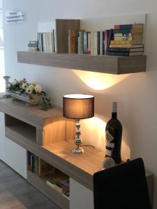 a table with a lamp and a bottle of wine at Apartamentos La Laguna in Fuente de Piedra