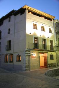 a large white building with a balcony on the side at Hotel Palaterna in Pastrana