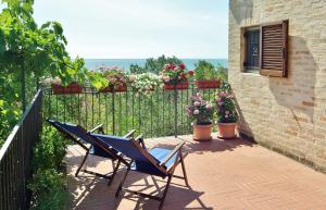 a patio with two chairs and a fence with flowers at Villa Fiorita in Grottammare