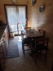 a kitchen with a table and chairs and a window at Heart of Vieira Do Minho - T2 Apartment in Vieira do Minho