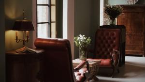 a living room with a chair and a vase of flowers at Moon and Chalice Boutique Hotel in Kunming