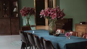 a table with a vase of pink flowers on it at Moon and Chalice Boutique Hotel in Kunming