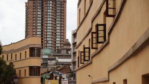 a group of tall buildings on a city street at Moon and Chalice Boutique Hotel in Kunming