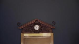 a clock on a wall above a window at Moon and Chalice Boutique Hotel in Kunming