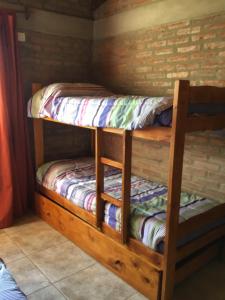 a couple of bunk beds in a room at La Soleada casas de campo in Nono