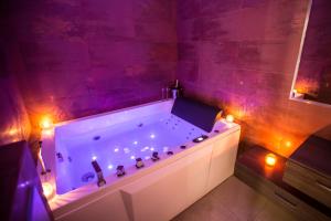 a bathroom with a large tub with lights in it at Residence du Louvre - Apartments - Prime location Palais & Croisette - Luxury Stay by LRA Cannes in Cannes