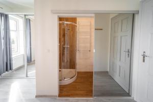 a bathroom with a tub and a shower in it at Black & White Vision Apartment - Centrum in Opole
