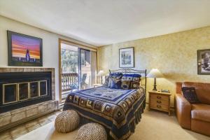 a bedroom with a bed and a fireplace at Cedar Lodge 309 in Frisco