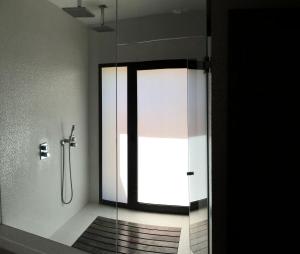 a bathroom with a shower with a glass door at Casas adosadas julieta in Ribadesella +71 photos