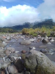 a river with rocks and mountains in the background at Breathtaking Volcan Mountain/River Views in Volcán