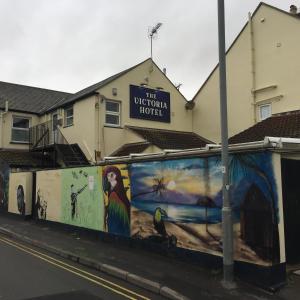 a wall with paintings on it in front of a building at The Victoria Hotel in Burnham on Sea