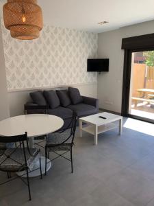 a living room with a couch and a table at Casas adosadas julieta in Ribadesella