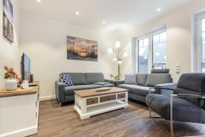 a living room with two couches and a table at Haus Jensen 3 in List