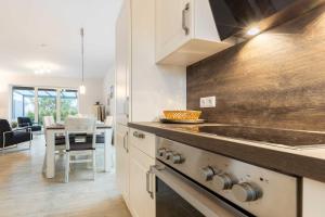 a kitchen with a stove and a dining room at Alte Waescherei _9461_ in List