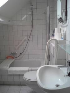 a bathroom with a toilet and a tub and a sink at Huis in de natuur in Epen +46 photos