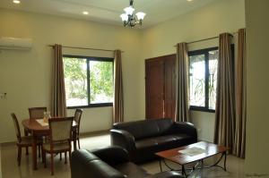 a living room with a couch and a table at Résidence Danna_ALPHA in Douala