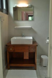 a bathroom with a sink and a mirror and a toilet at Résidence Danna_ALPHA in Douala +9 photos