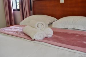 a pile of towels sitting on top of a bed at Résidence Danna_ALPHA in Douala