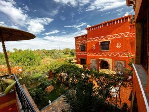 a building with a garden in front of it at Riad Chay & Boutique in Ouarzazate