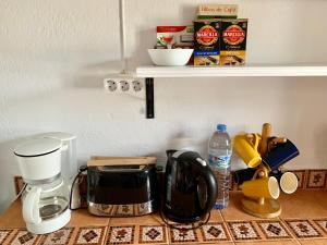 a kitchen counter with a coffeemaker and a coffee maker at La Casilla- La Almona Chica in El Chorro