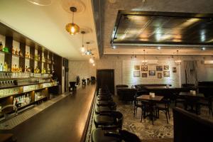 a restaurant with a bar with tables and chairs at Altyn Shatyr Hotel and Restaurant in Aksay