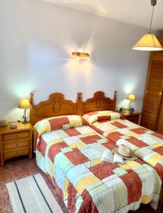 a bedroom with a bed and two night stands and lamps at Casas Balcón del Mar in El Paso